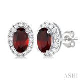 5x3 MM Oval Shape Garnet and 1/8 Ctw Round Cut Diamond Halo Semi-Precious Stud Earrings in 14K White Gold